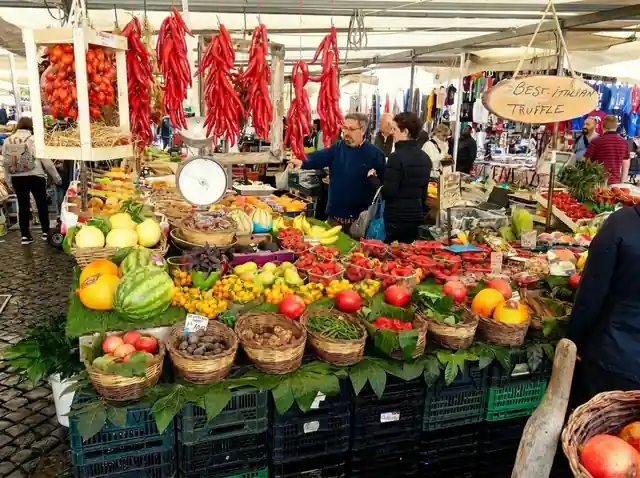 The morning market at Campo de' Fiori in Rome, with produce stalls and hanging peppers